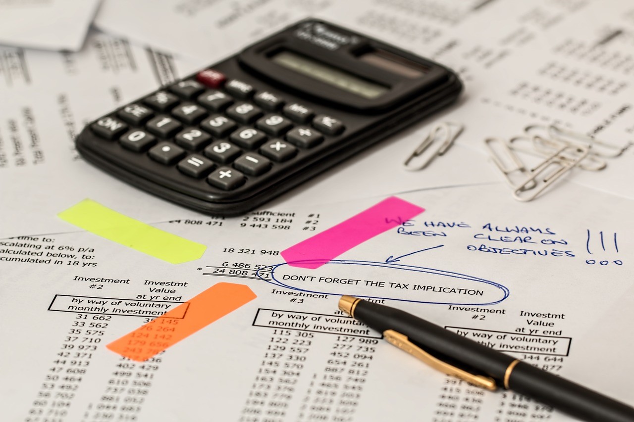 calculator, pen, and tax paperwork