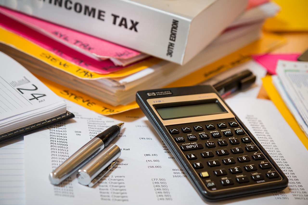 income tax documents, calendar, pen, and calculator