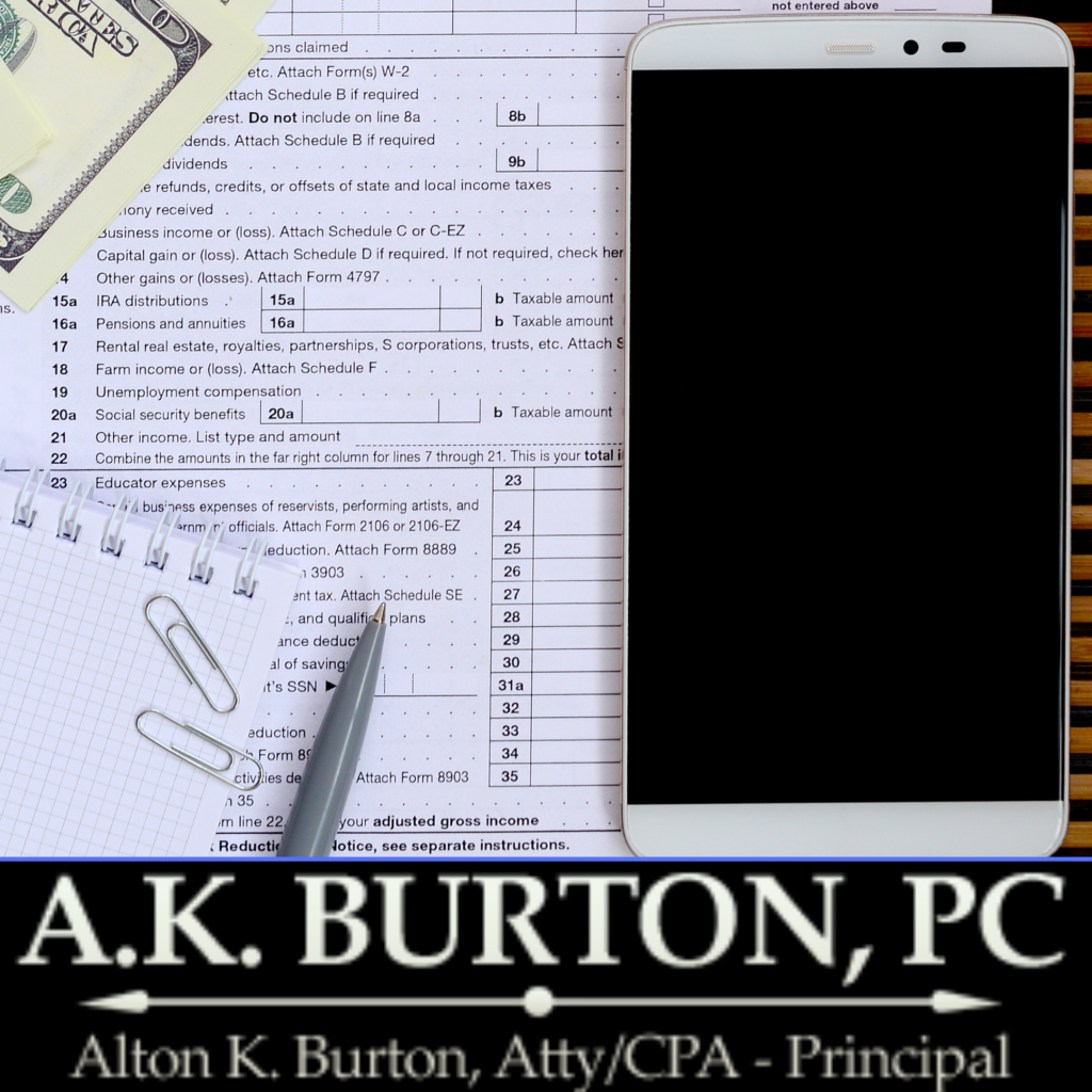 tax form, iPhone, pen, notebook, paper clips, and a hundred dollar bill are arranged above the A.K. Burton, PC logo