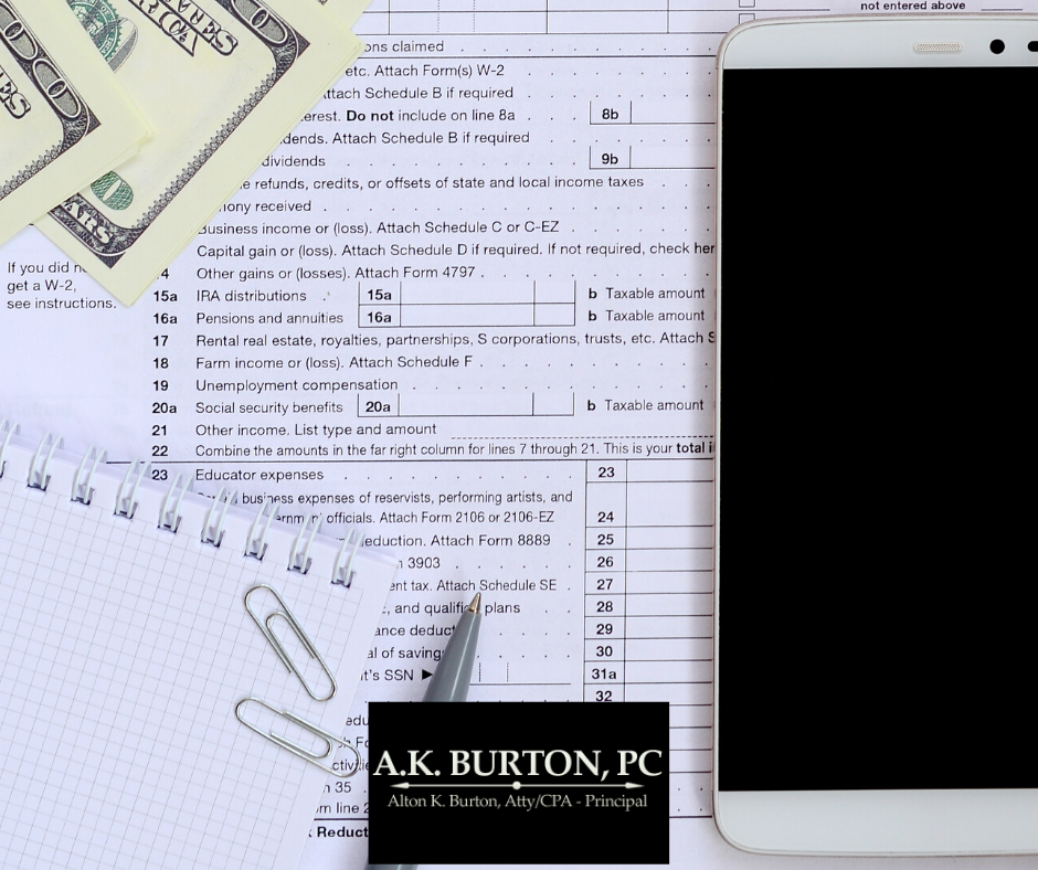 AK Burton logo, cell phone, and hundred dollar bills on a tax form