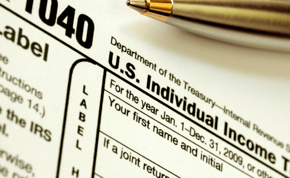 closeup of a 1040 tax form and pen