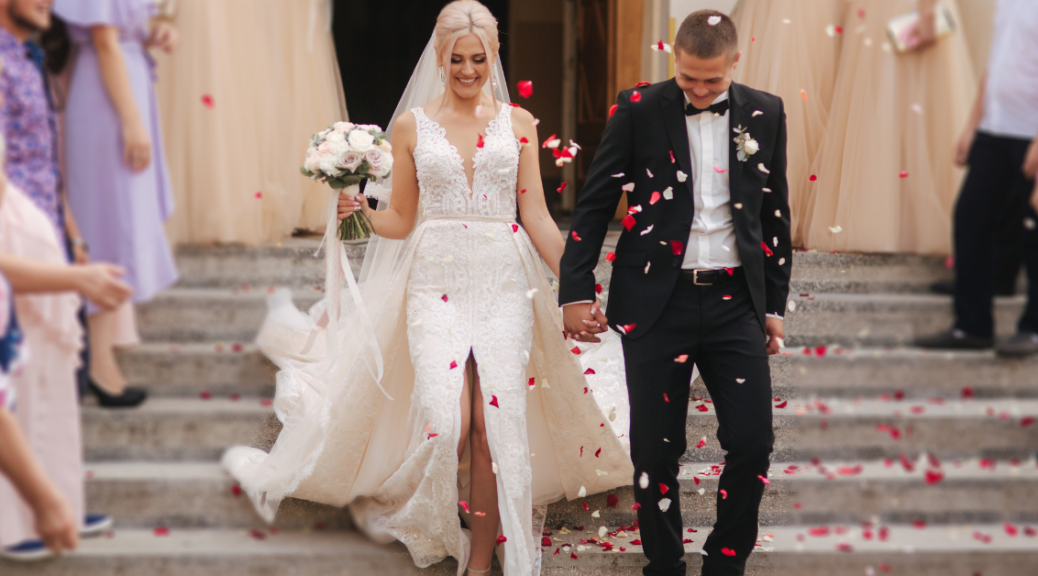just married couple walking hand in hand, flower petals all around